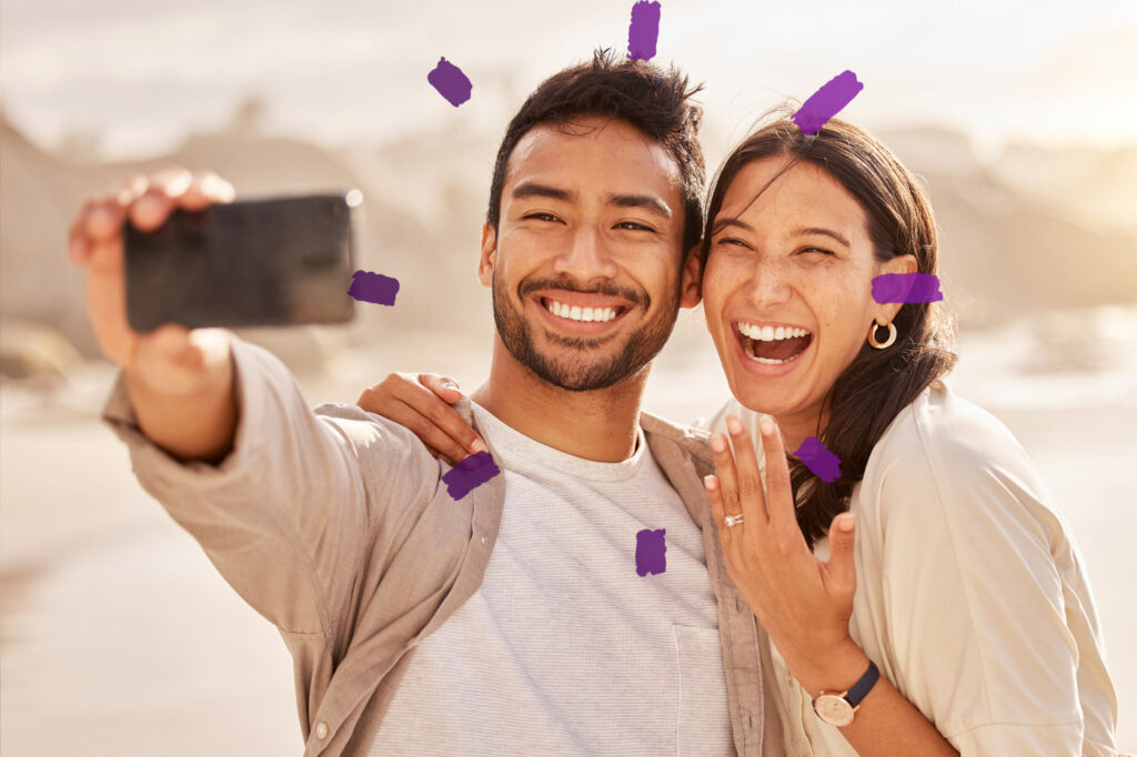 Loving couple taking a selfie together and smiling.